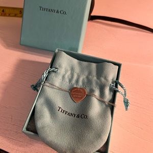 Tiffany double chain silver bracelet with rose gold charm. Normal wear & tear